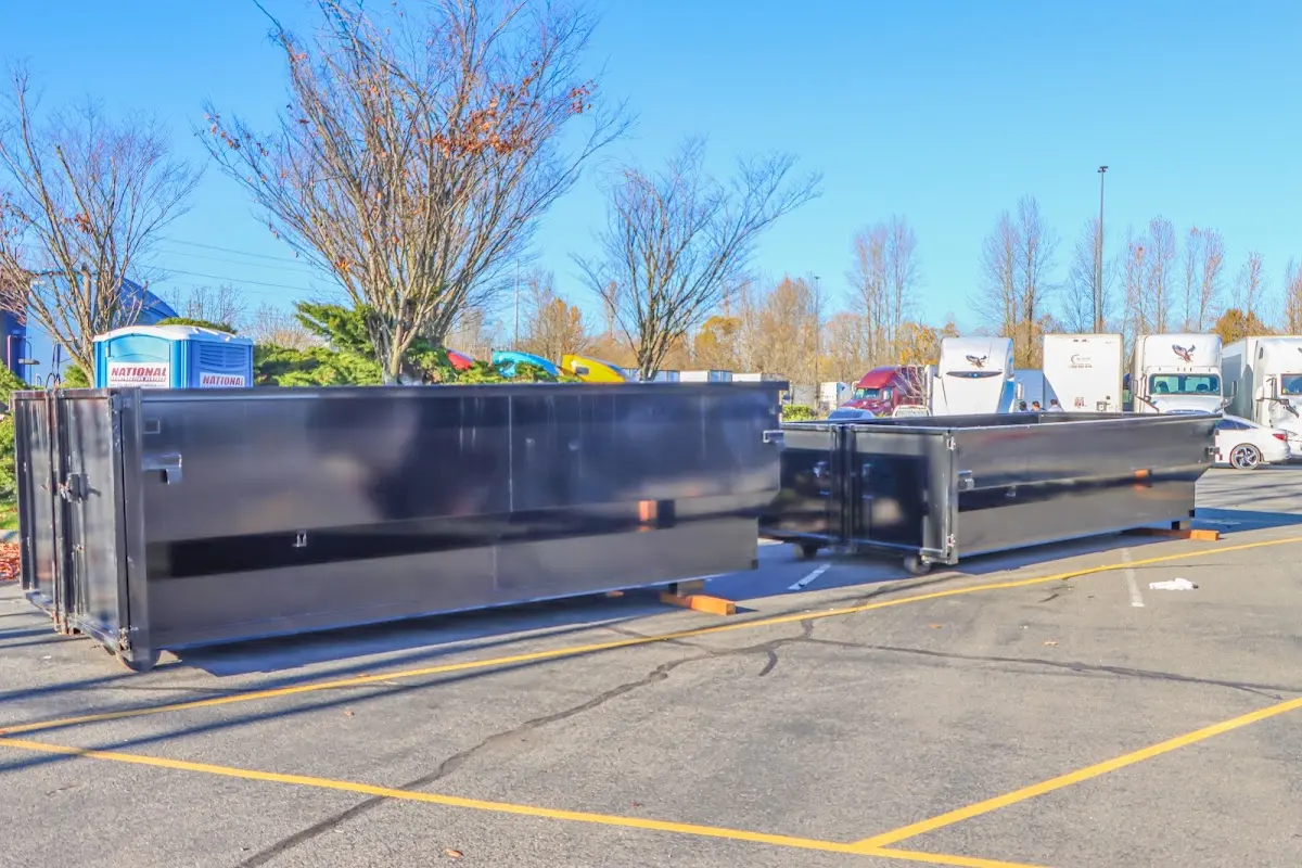 Professional dumpster rental service with roll-off container on residential driveway in Gridley